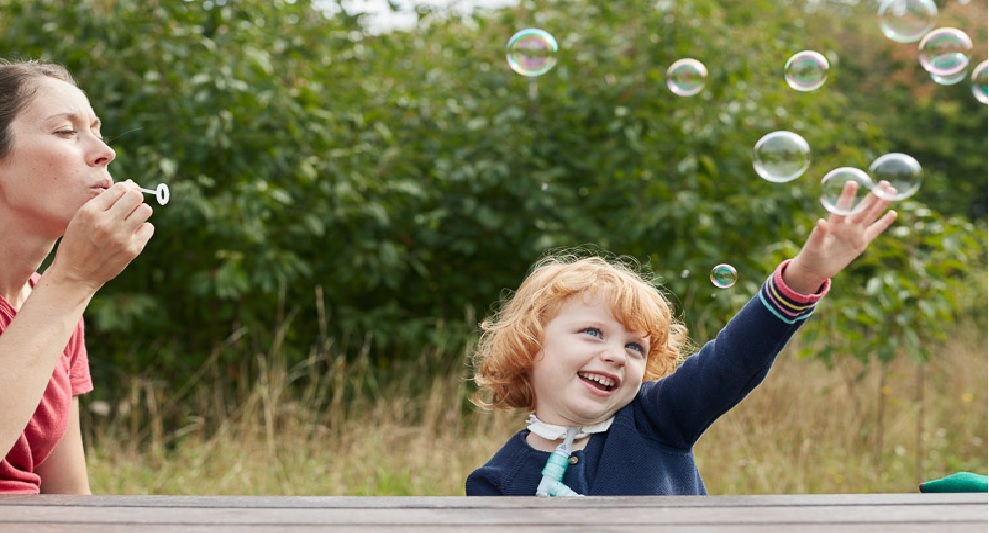 Image of child playing with bubbles