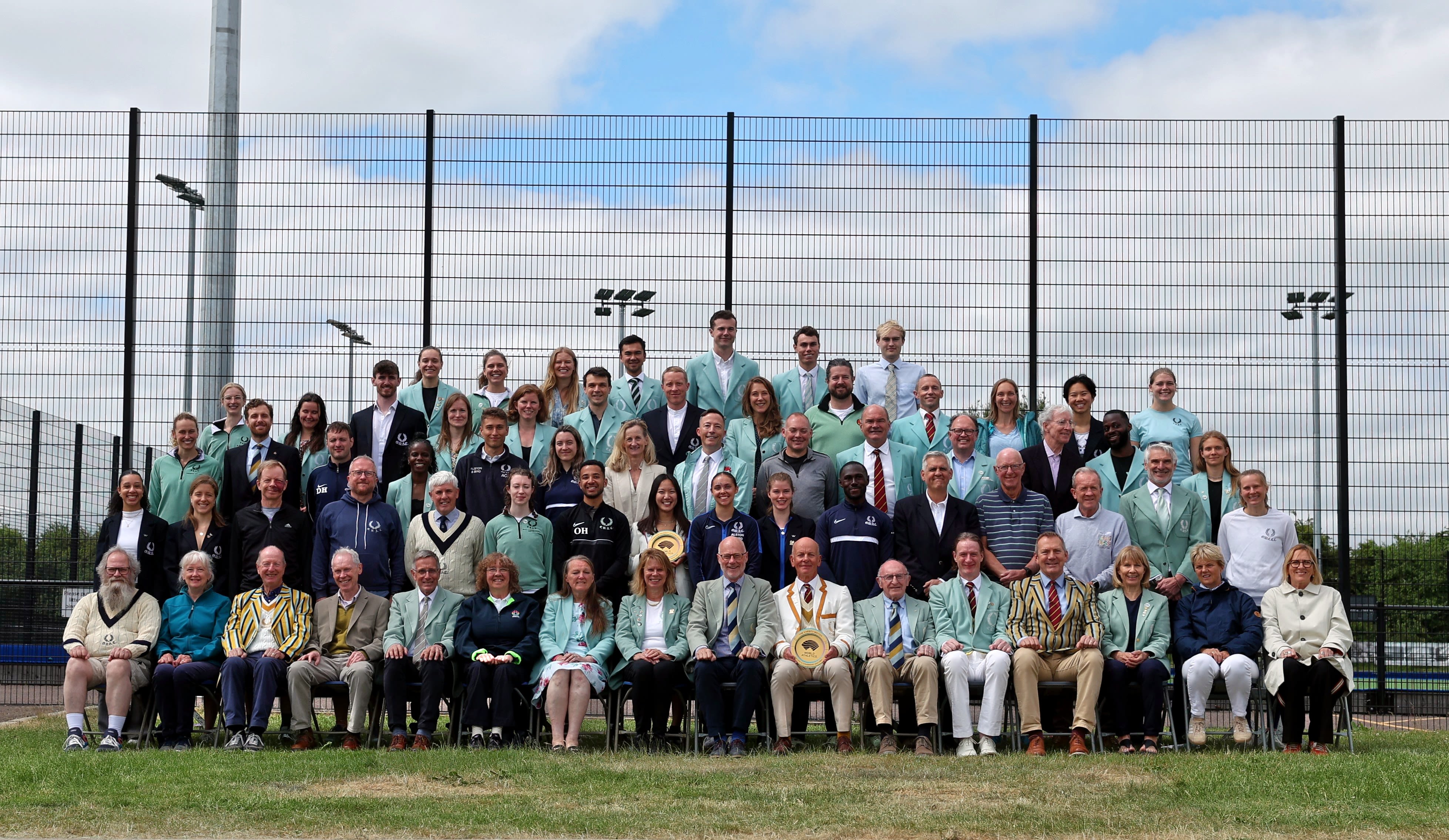 Members of CUAC pose for a group photo on tiered seating.