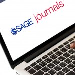 SAGE Journals logo on laptop