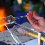 Image of someone blowing glass