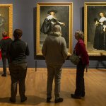 Image of people looking at art in a museum