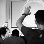 man with his hand up