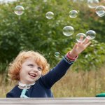 Image of child playing with bubbles