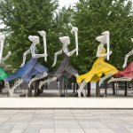 Women in Olympic colours with flames