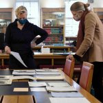 Dr Katrina Dean, Keeper of Archives and Modern Manuscripts, studying some of the paper archive with Dr Jessica Gardner, Universi