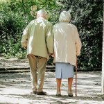 Elderly couple taking a walk through the park