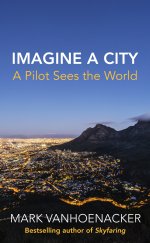 Front cover showing a cityscape at dusk, with mountains on the right and a lit up city on the left