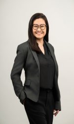 Dr Valerie Yang wearing a dark grey blazer and smiling.