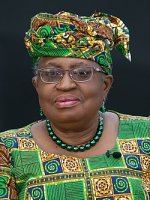 Photo of Okonjo-Iweala, dressed in traditional African dress in green yellow and black blocks