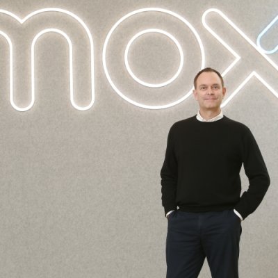 pportrait photograph of a man against a corporate backdrop 