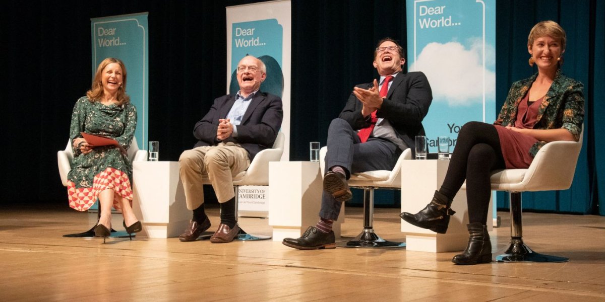 Four seated panellists share a laugh.
