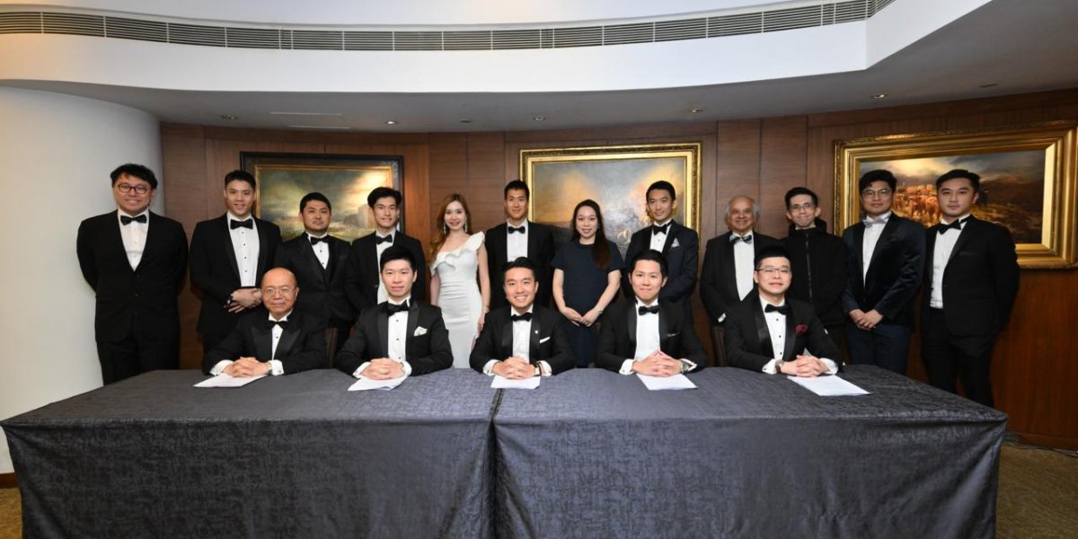 The committee in black tie posing for a formal photo