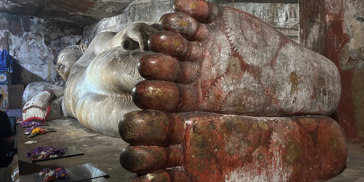 Budda laying down showing his feet in temple