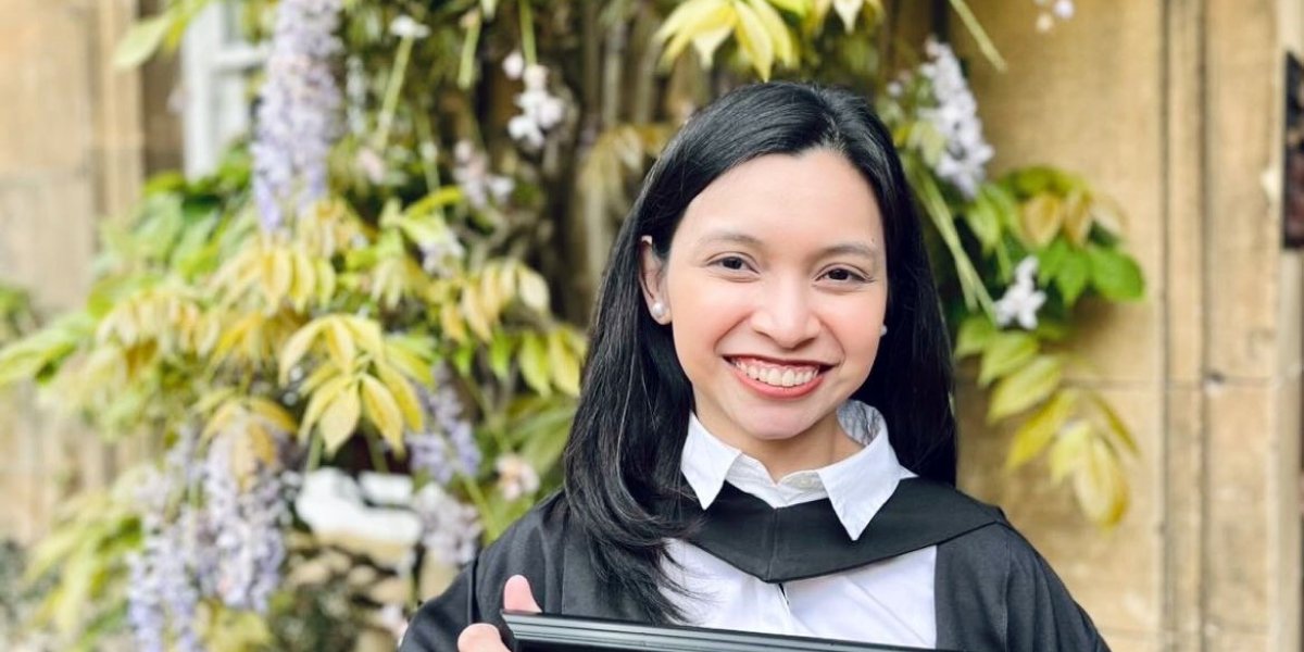 Rogie Vasquez holding her degree certificate