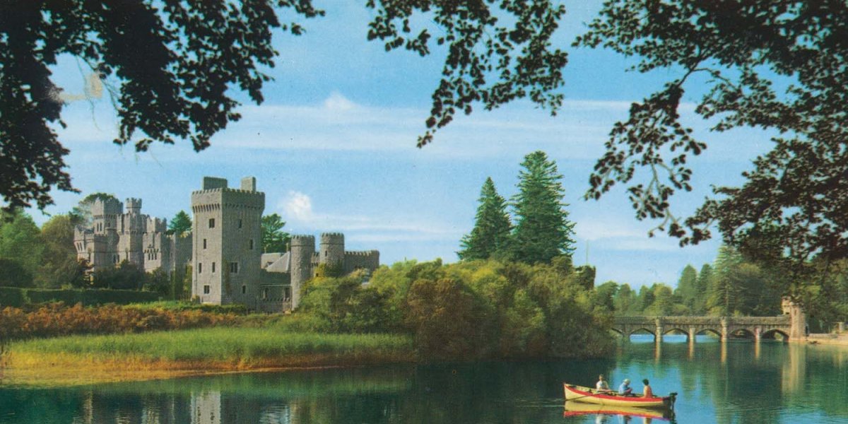 Old postcard of rural scene featuring a castle and rowing boat