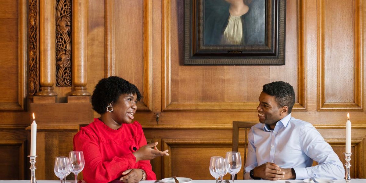 Okechukwu Nzelu and Aiseosa Eweka-Okera talking at a table