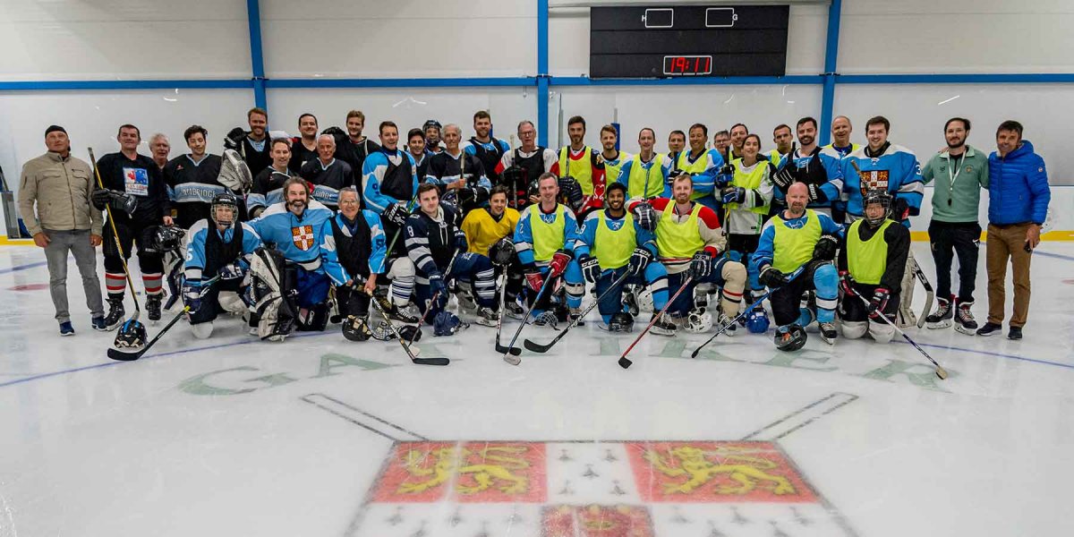Group photo on the ice with teams in uniform