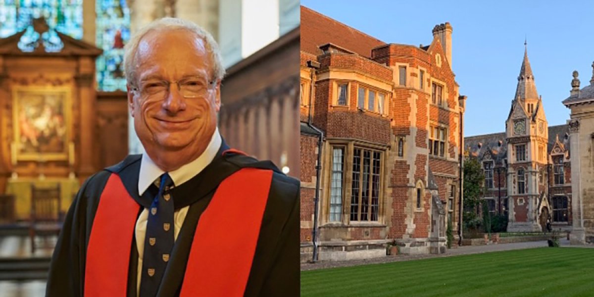 Lord Chris Smith standing in a panelled wood chapel with stained glass above, wearing black robes with panels of red.