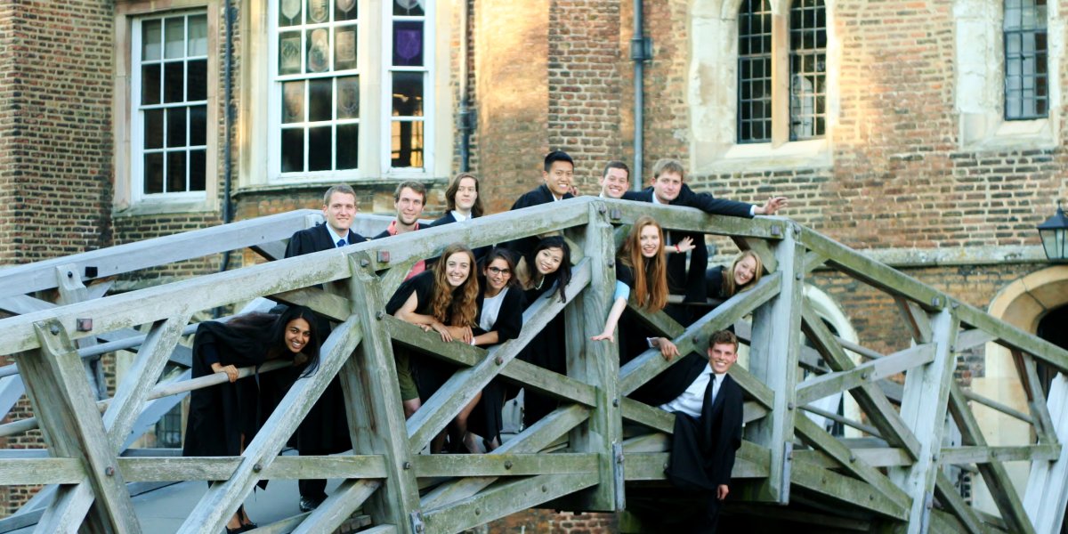 Oliver with friends posing on Cambridge's mathematical bridge