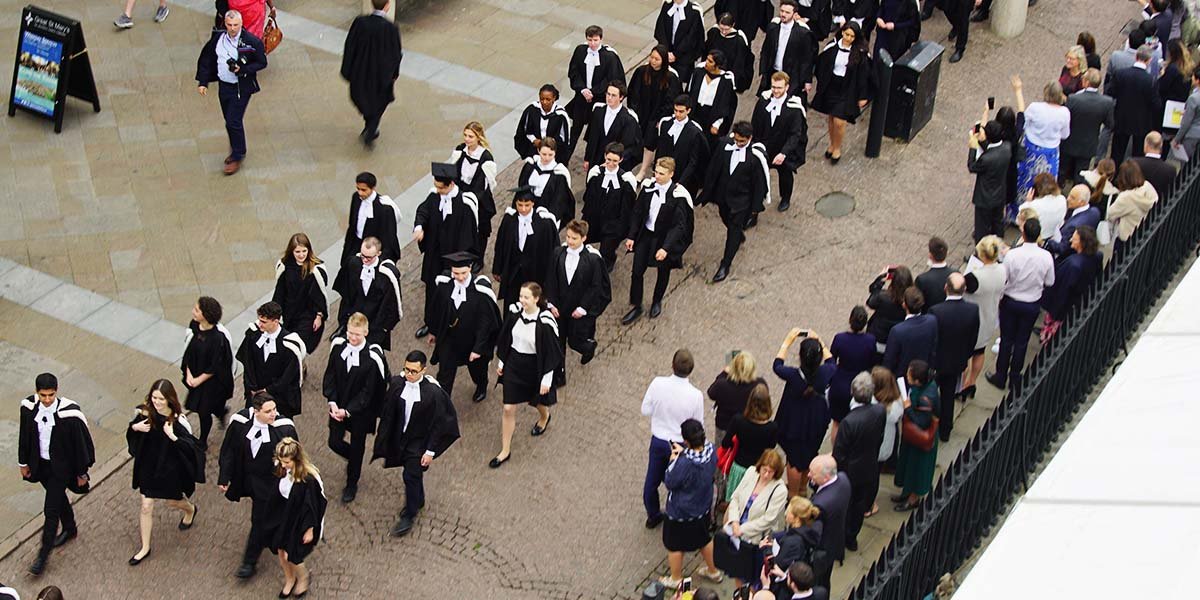 Graduands from King's College Cambridge process towards Senate House in 2019.