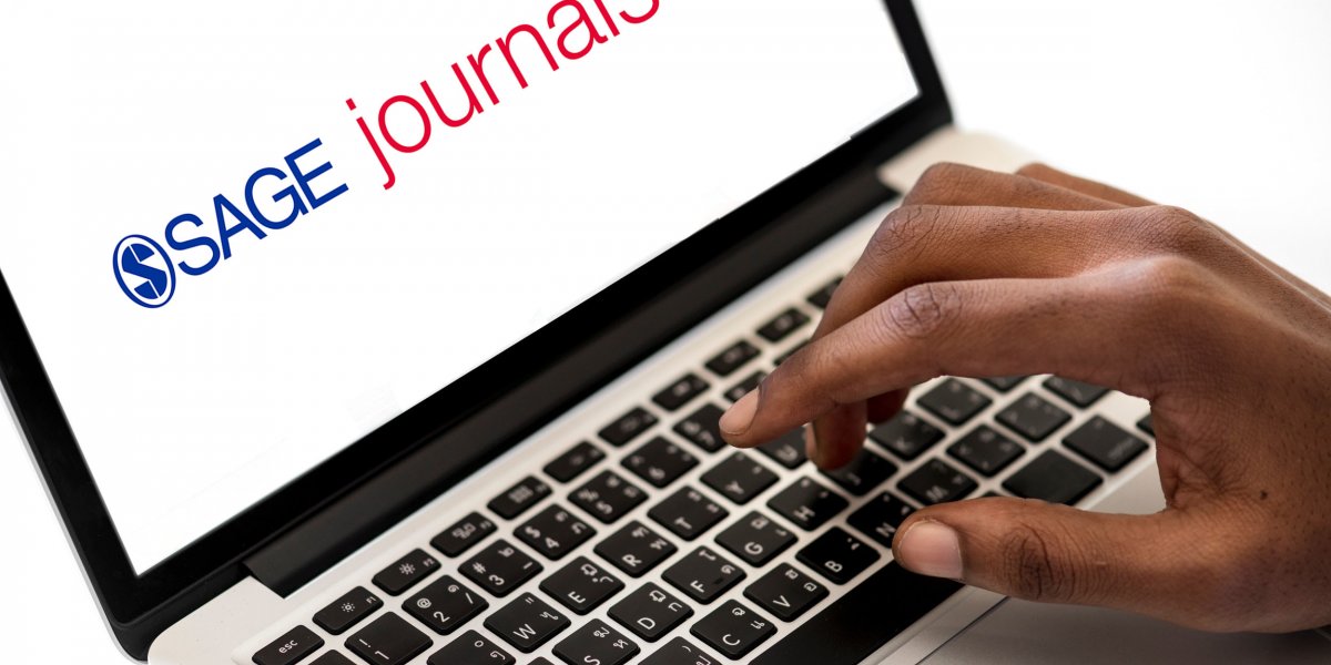 SAGE Journals logo on laptop