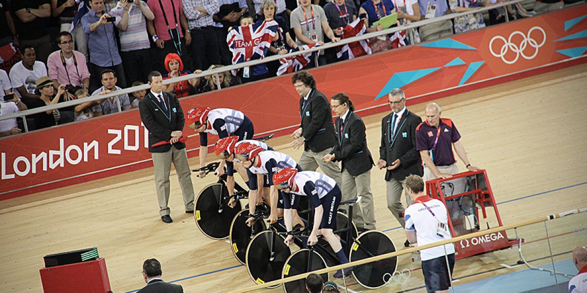 Four cyclists at the start line in the velodrome at the London 2012 Olympics. Photo by Simon Connellan on Unsplash.