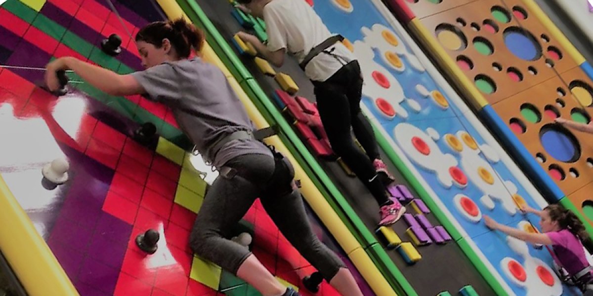 Girls climbing a wall