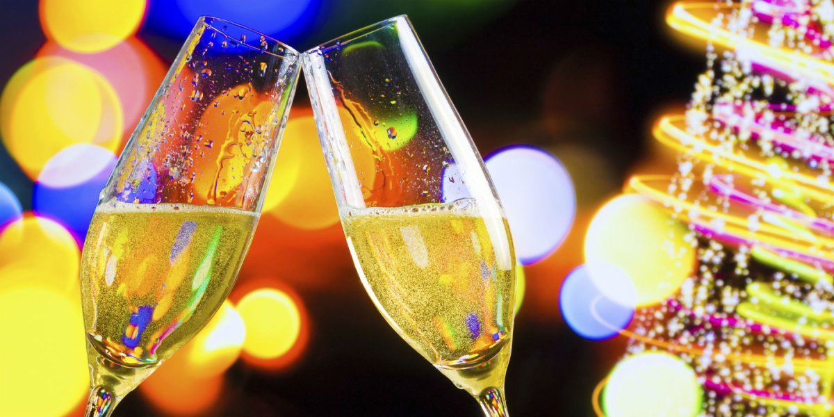 two Champagne glasses being clinked together to say 'cheers'