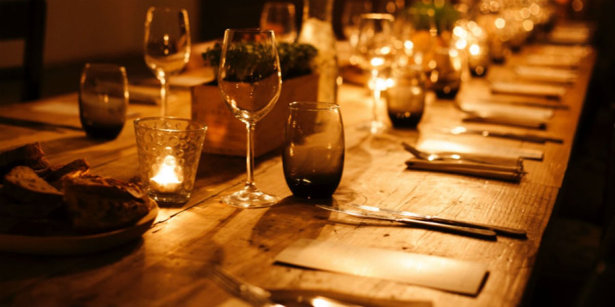 Image of dining table lit by candles