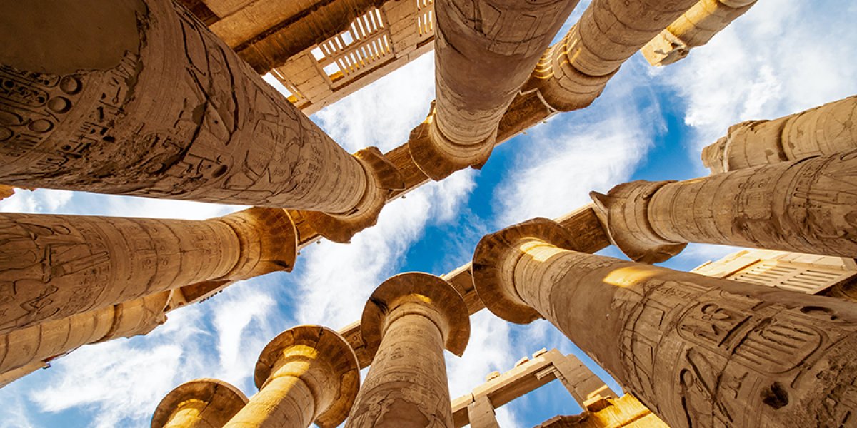 Photo of Karnak Hypostyle hall columns and clouds in the Temple at Luxor Thebes in Eygpt
