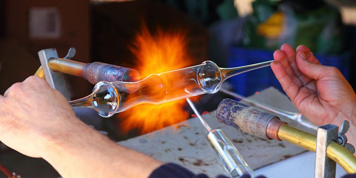 Image of someone blowing glass