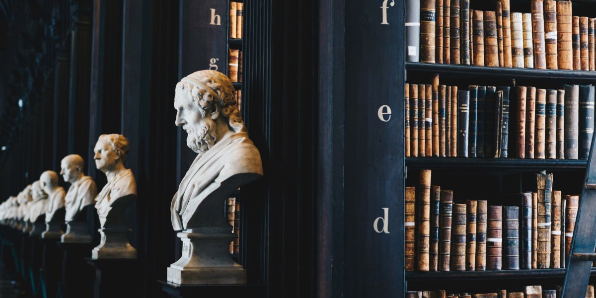 Image of a library with books and sculptures