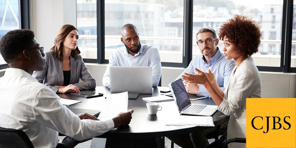 Millennial black businesswoman addressing colleagues at a corporate business meeting, close up