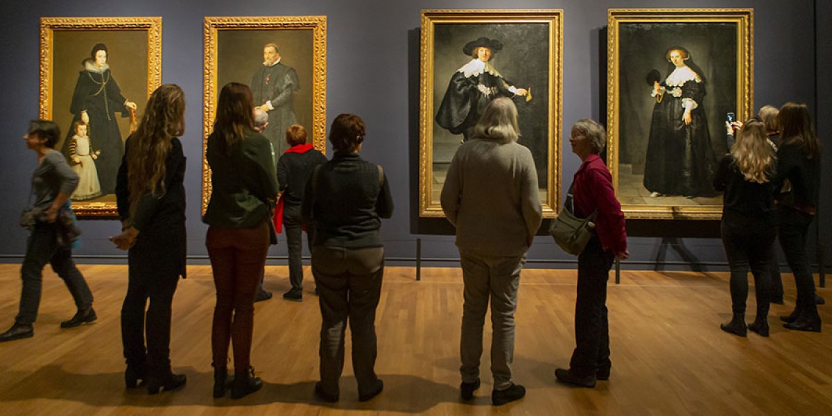 Image of people looking at art in a museum