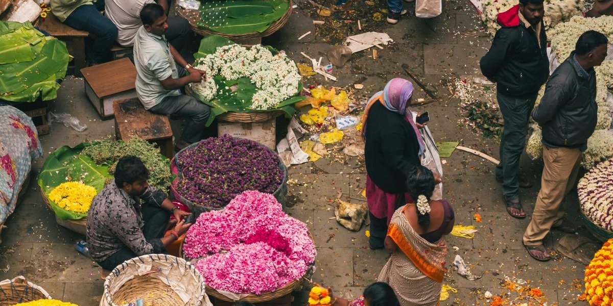 people standing around a flower stall in Bangalore