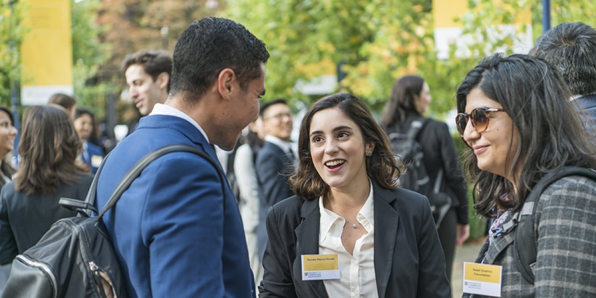 Woman chatting at CJBS event