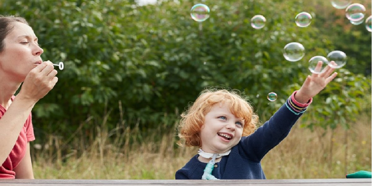 Image of child playing with bubbles