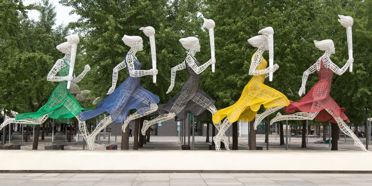 Women in Olympic colours with flames