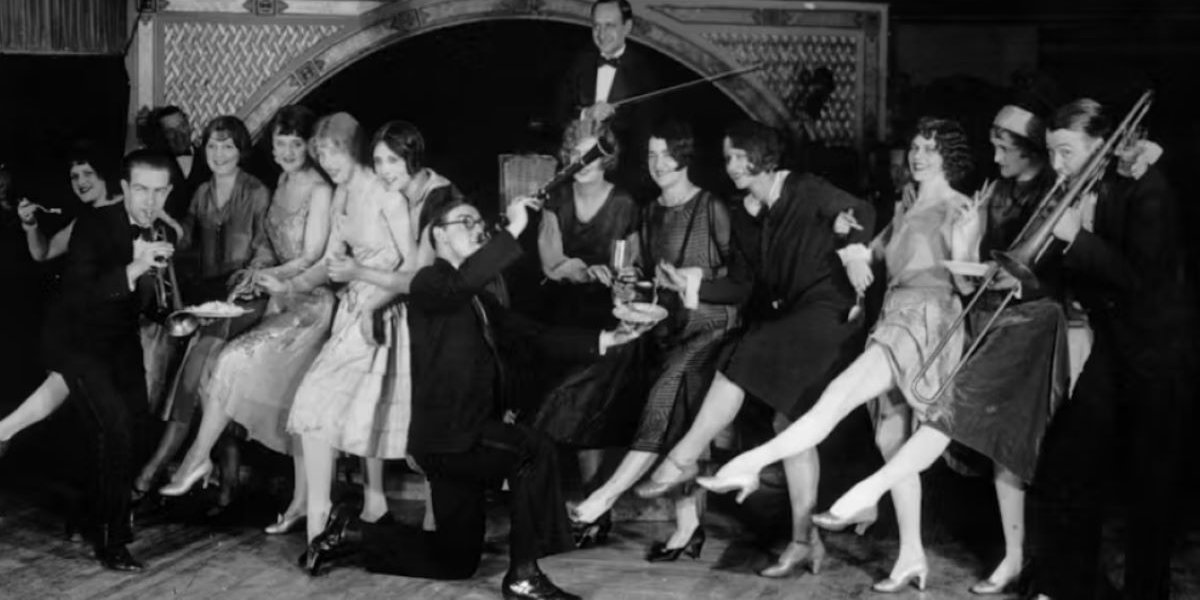 Black and White photo of people dancing and playing instruments in a jazz club