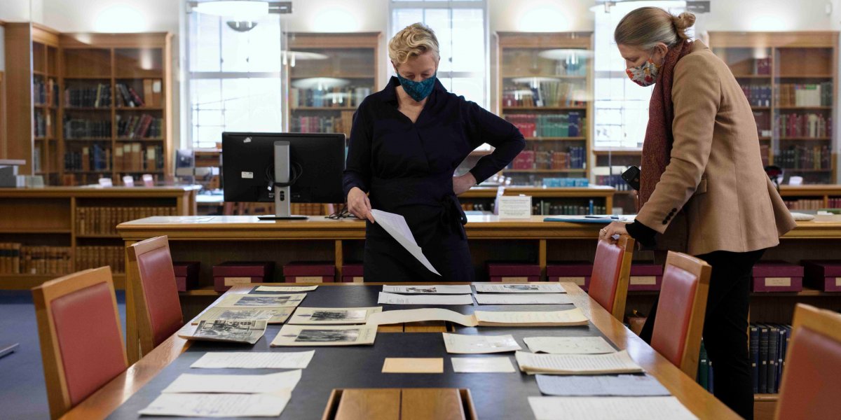 Dr Katrina Dean, Keeper of Archives and Modern Manuscripts, studying some of the paper archive with Dr Jessica Gardner, Universi