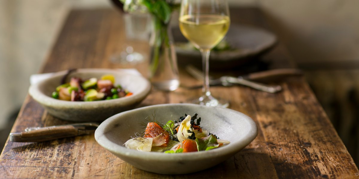 wine glass and small plates of food