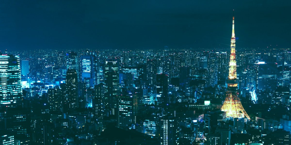 Nighttime cityscape of Tokyo, with Tokyo Tower illuminated and an expanse of skyscrapers.