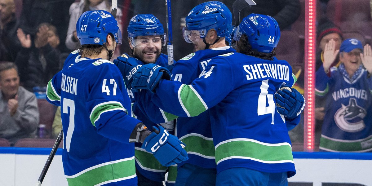 Vancouver Canucks Ice Hockey players celebrate scoring a goal on the ice