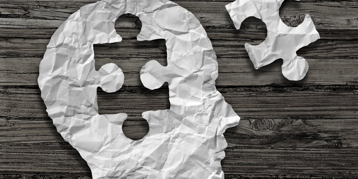Wisdom abstract - A persons head made up of a jigsaw with one piece removed.