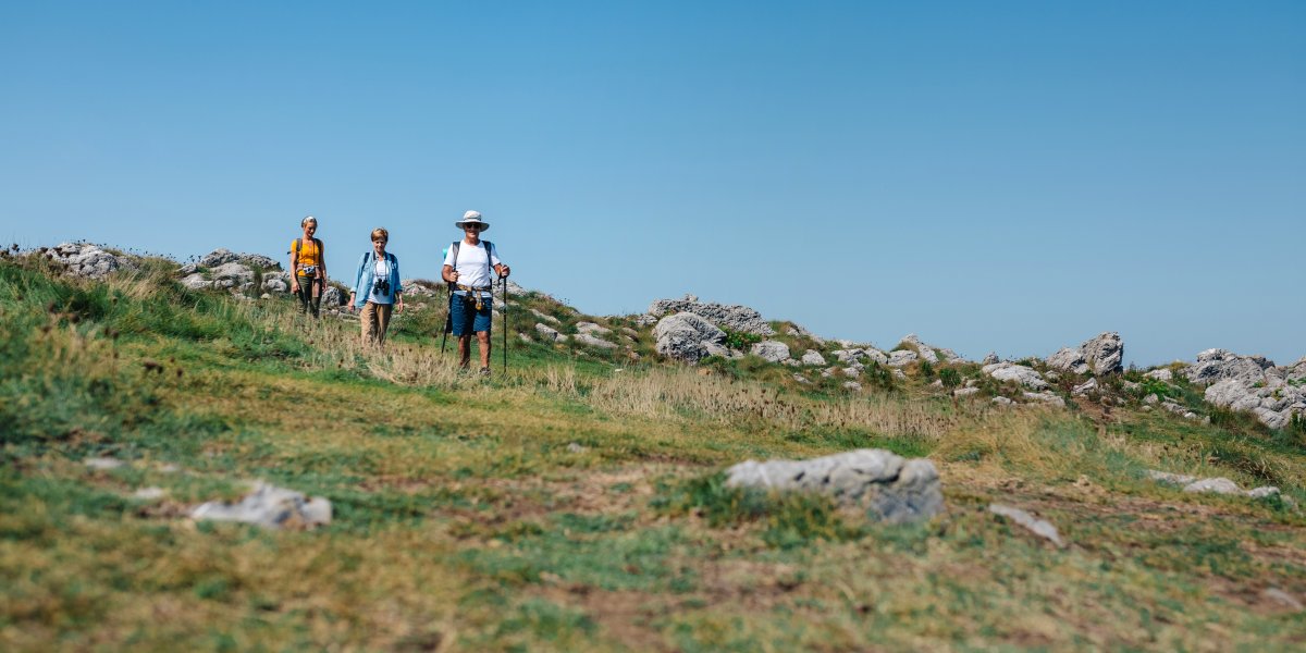 Three people walking in the hills