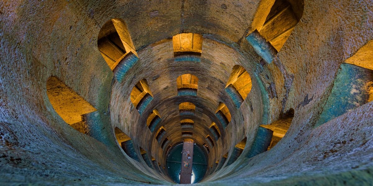 cylinder shaft surrounded by a double helix spiral staircase and arch windows in Orvieto medieval city, Umbria, Italy