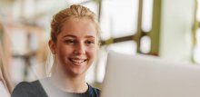 Smiling girl looking at computer