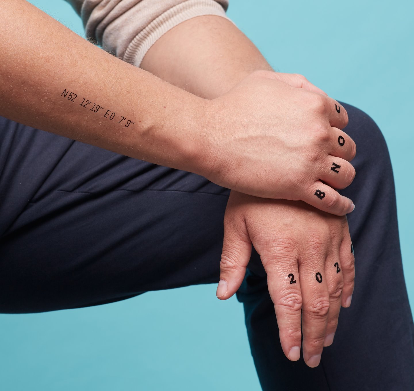BNOC temporary tattoo across knuckles.