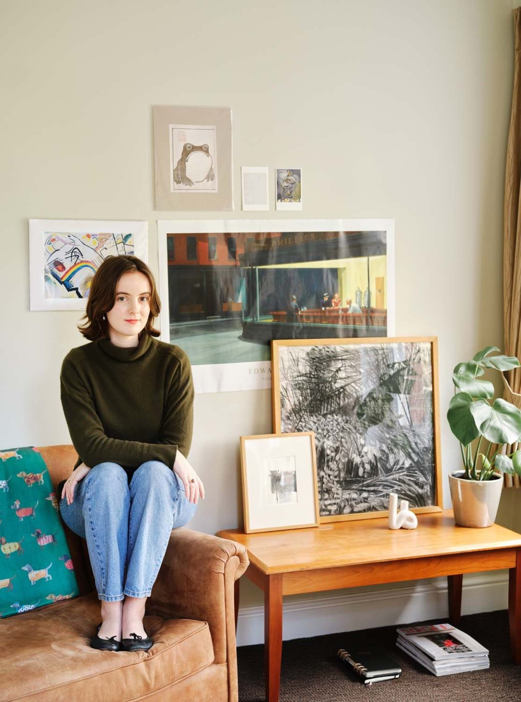 Imogen Grimes sitting by paintings