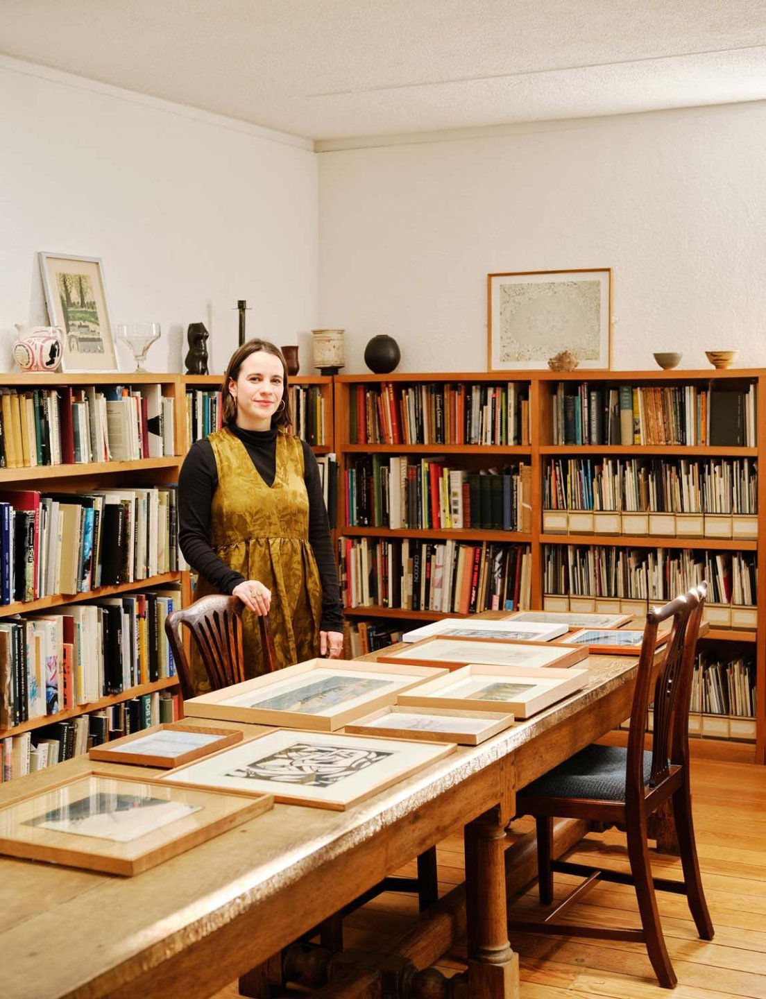 Naomi Polonsky standing by paintings